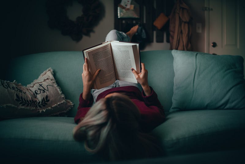 A cozy reading nook with a stack of books