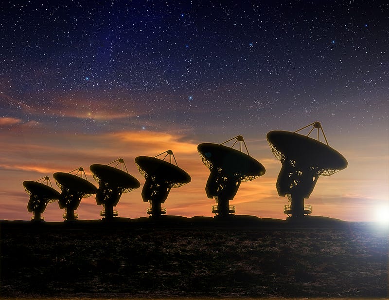 Radio telescopes observing the universe at dusk.