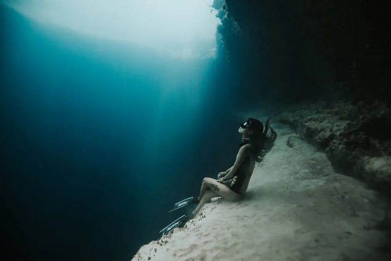 A diver experiencing the descent into the deep sea.