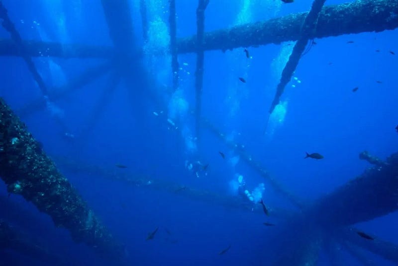 An oil drilling platform submerged in the ocean.