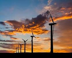 Wind turbines generating clean energy against a blue sky.